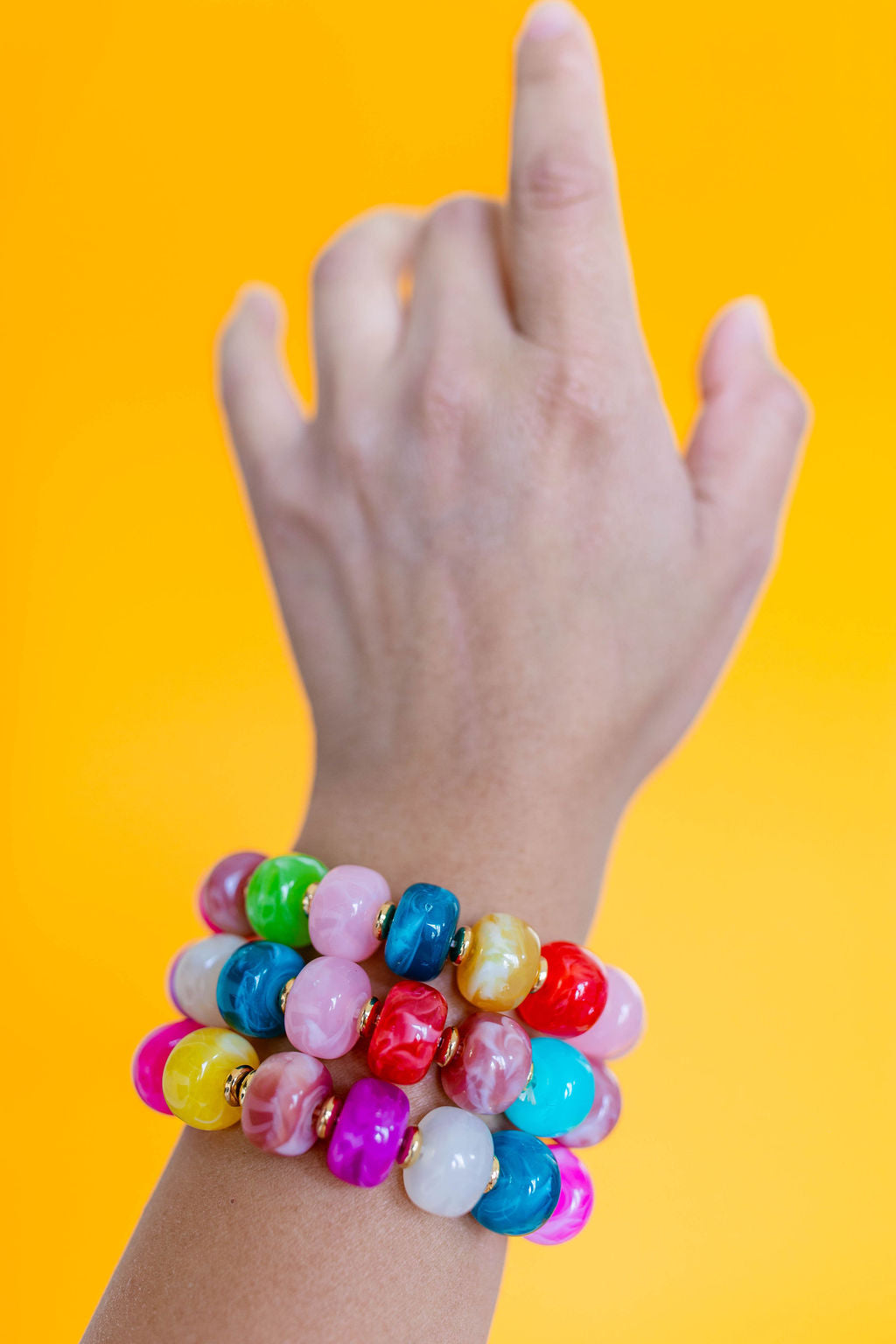 Model wearing a rainbow beaded bracelet and matching beaded necklace with a You're Not Being Weird Enough graphic tee